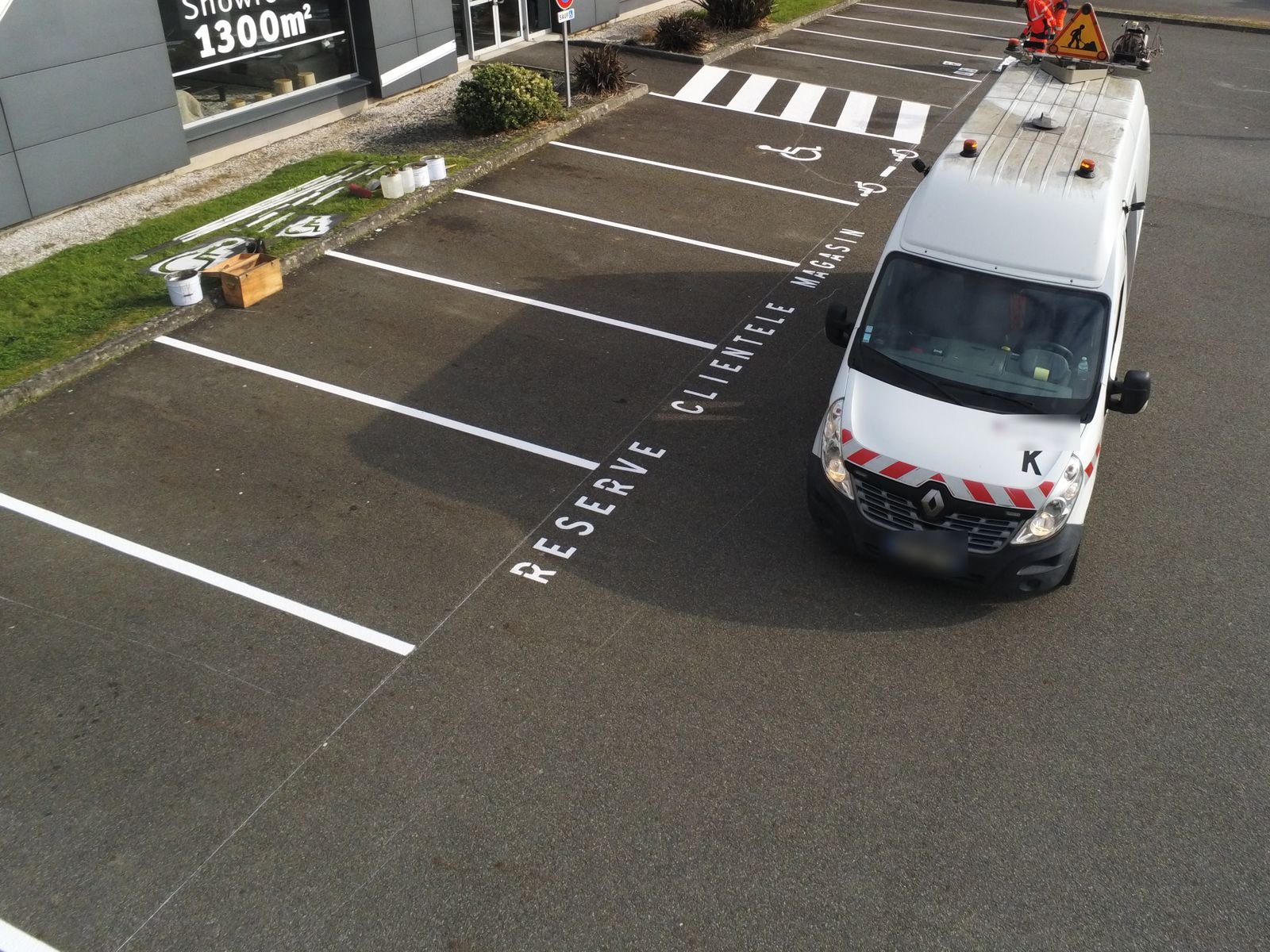 Vue aérienne d’un parking de commerce pendant le marquage des places