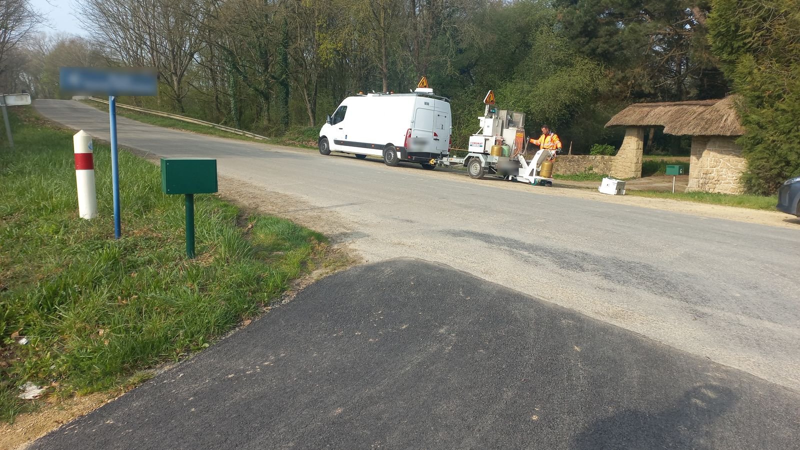 Machine de marquage et véhicule de chantier sur une route communale